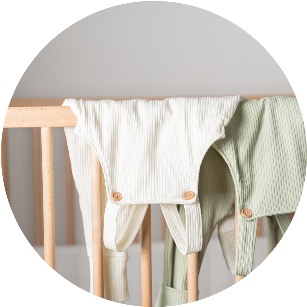 Bao Baby Wear overalls hanging in vanilla and matcha colours. Soft cotton rib material for both overalls