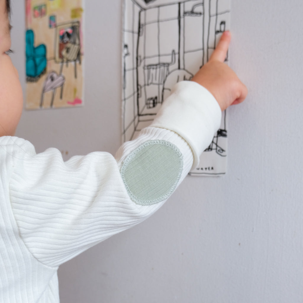 Check out our cute elbow patch on the vanilla ribbed cardigan.