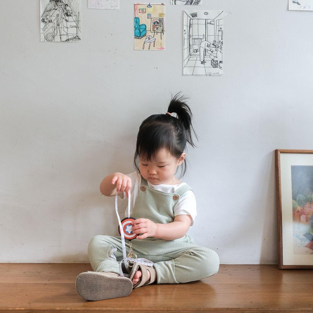 Check out our model wearing BAO Baby Wear overalls in matcha.