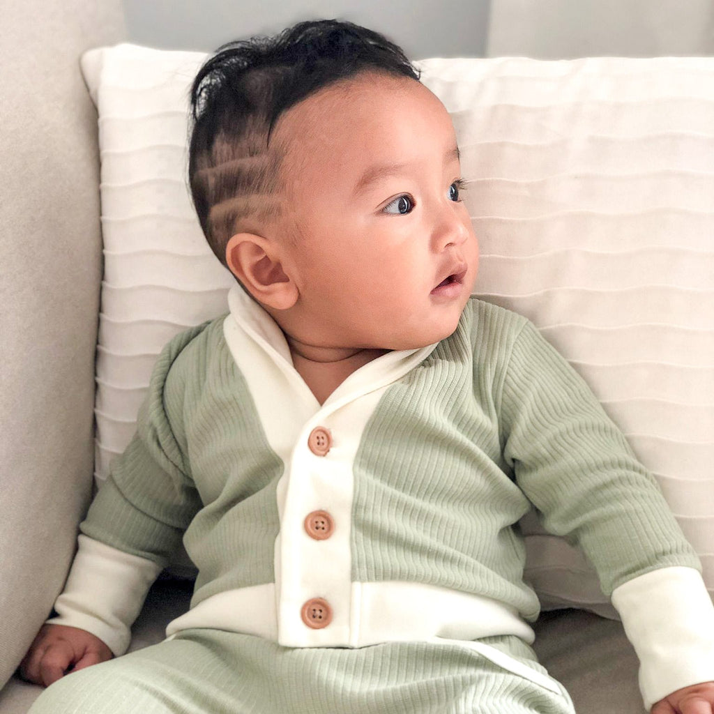 Our model wearing ribbed cardigan and lounge pants in matcha, size 6-12 months.