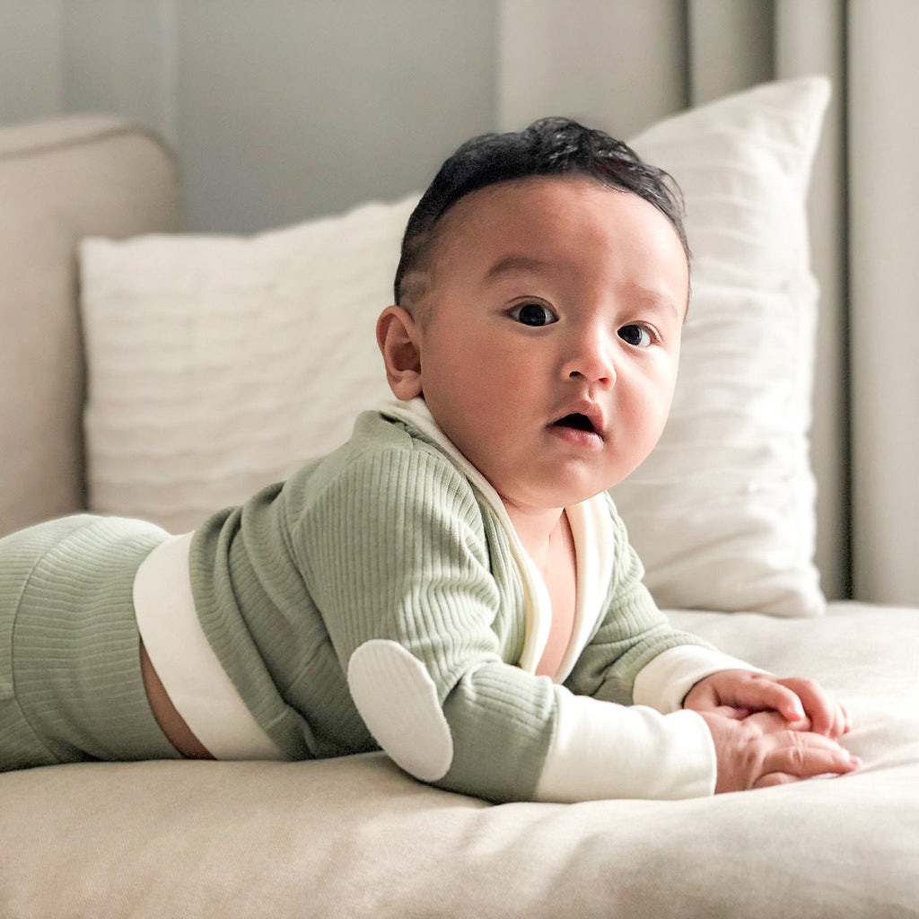Our model posing in ribbed cardigan and lounge pants in matcha.