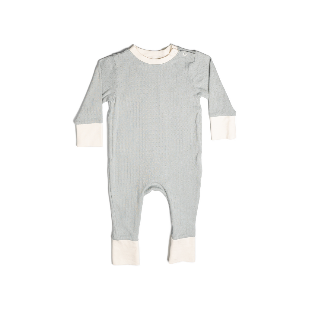 Pyjamas in a soft blue (butterfly pea), with vanilla colour contrasting wrist and ankle cuffs. Made from pointelle patterned cotton. Shown in its large setting.