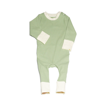 Pyjamas in a mossy green (matcha), with vanilla colour contrasting wrist and ankle cuffs. Made from ribbed cotton. Shown in its large setting.
