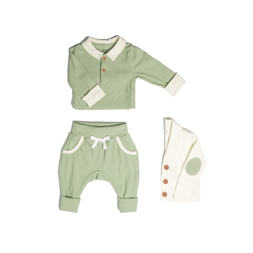 The toddler essentials bundle, consisting of a collared bodysuit in matcha ribbed cotton, paired with lounge pants in matcha and ribbed cotton and a cardigan in vanilla ribbed cotton.