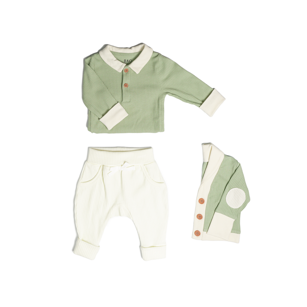 The toddler essentials bundle, consisting of a collared bodysuit in matcha ribbed cotton, paired with lounge pants in vanilla and ribbed cotton and a cardigan in matcha ribbed cotton.