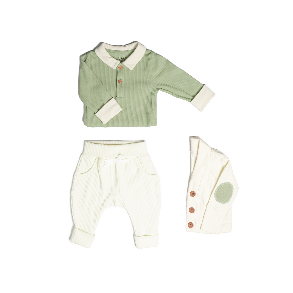 The toddler essentials bundle, consisting of a collared bodysuit in matcha ribbed cotton, paired with lounge pants in vanilla and ribbed cotton and a cardigan in vanilla ribbed cotton.