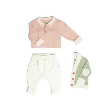 The toddler essentials bundle, consisting of a collared bodysuit in peach pointelle patterned cotton, paired with lounge pants in vanilla and ribbed cotton and a cardigan in matcha ribbed cotton.