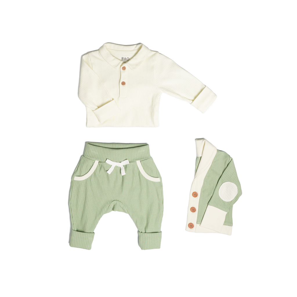 The toddler essentials bundle, consisting of a collared bodysuit in vanilla ribbed cotton, paired with lounge pants in matcha and ribbed cotton and a cardigan in matcha ribbed cotton.