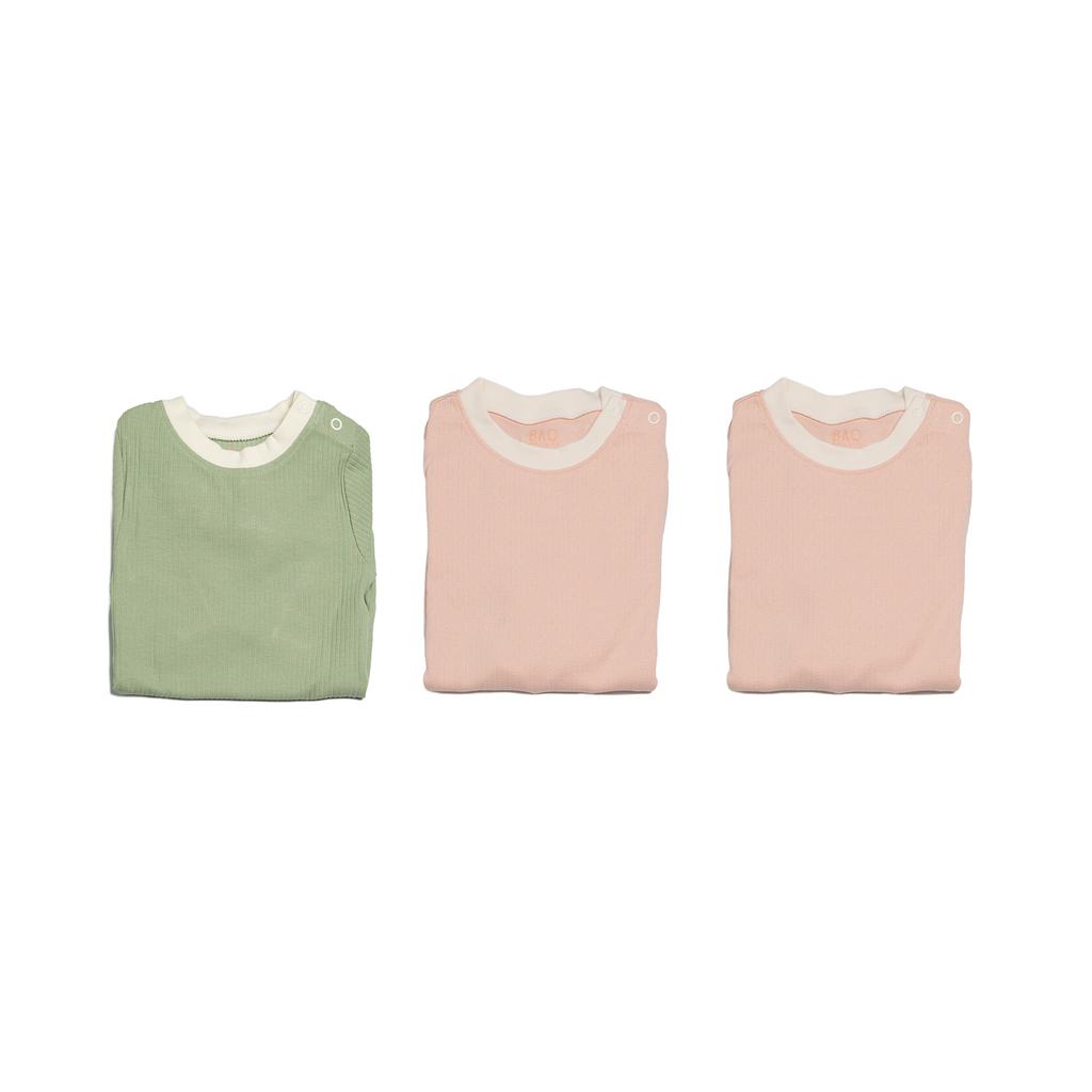 The newborn sleepy time bundle, consisting of 3 sets of pyjamas One in ribbed cotton matcha, two in pointelle cotton peach.