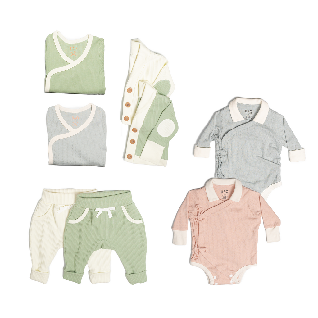 The ultimate earth-side bundle, consisting of a 2 sets of pointelle cotton kimono bodysuits, one in butterfly pea and one in peach, 2 pairs of ribbed cotton lounge pants, one in matcha and one in vanilla, 2 sets of ribbed cotton cardigans, one in matcha and one in vanilla, 2 sets of kimono pyjamas, one in ribbed cotton matcha and one in pointelle cotton butterfly pea.