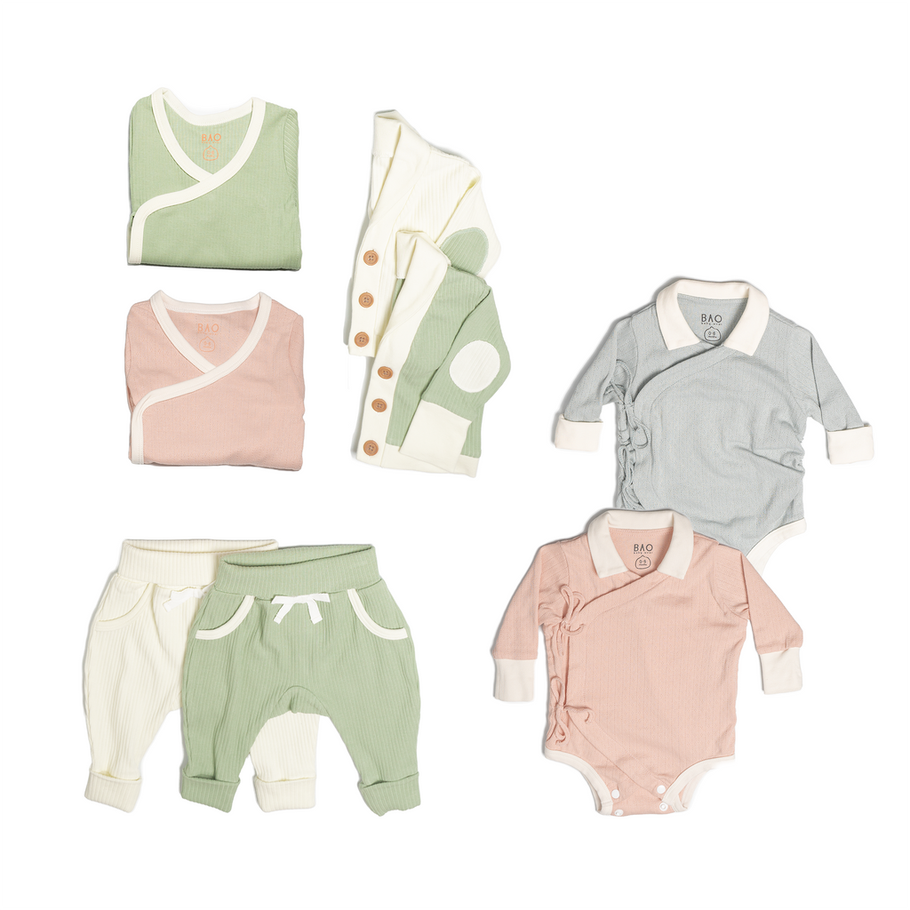 The ultimate earth-side bundle, consisting of a 2 sets of pointelle cotton kimono bodysuits, one in butterfly pea and one in peach, 2 pairs of ribbed cotton lounge pants, one in matcha and one in vanilla, 2 sets of ribbed cotton cardigans, one in matcha and one in vanilla, 2 sets of kimono pyjamas, one in ribbed cotton matcha and one in pointelle cotton peach.