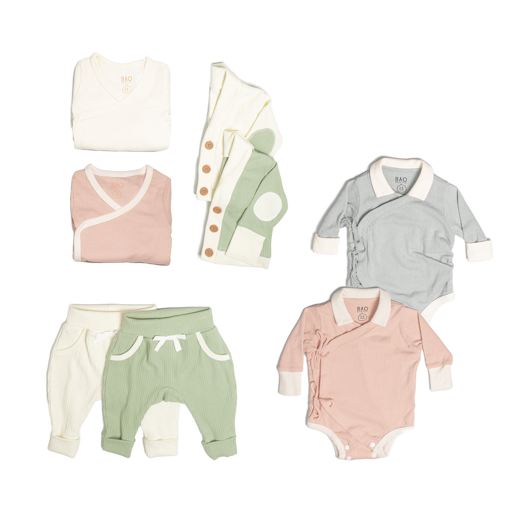 The ultimate earth-side bundle, consisting of a 2 sets of pointelle cotton kimono bodysuits, one in butterfly pea and one in peach, 2 pairs of ribbed cotton lounge pants, one in matcha and one in vanilla, 2 sets of ribbed cotton cardigans, one in matcha and one in vanilla, 2 sets of kimono pyjamas, one in ribbed cotton vanilla and one in pointelle cotton peach.