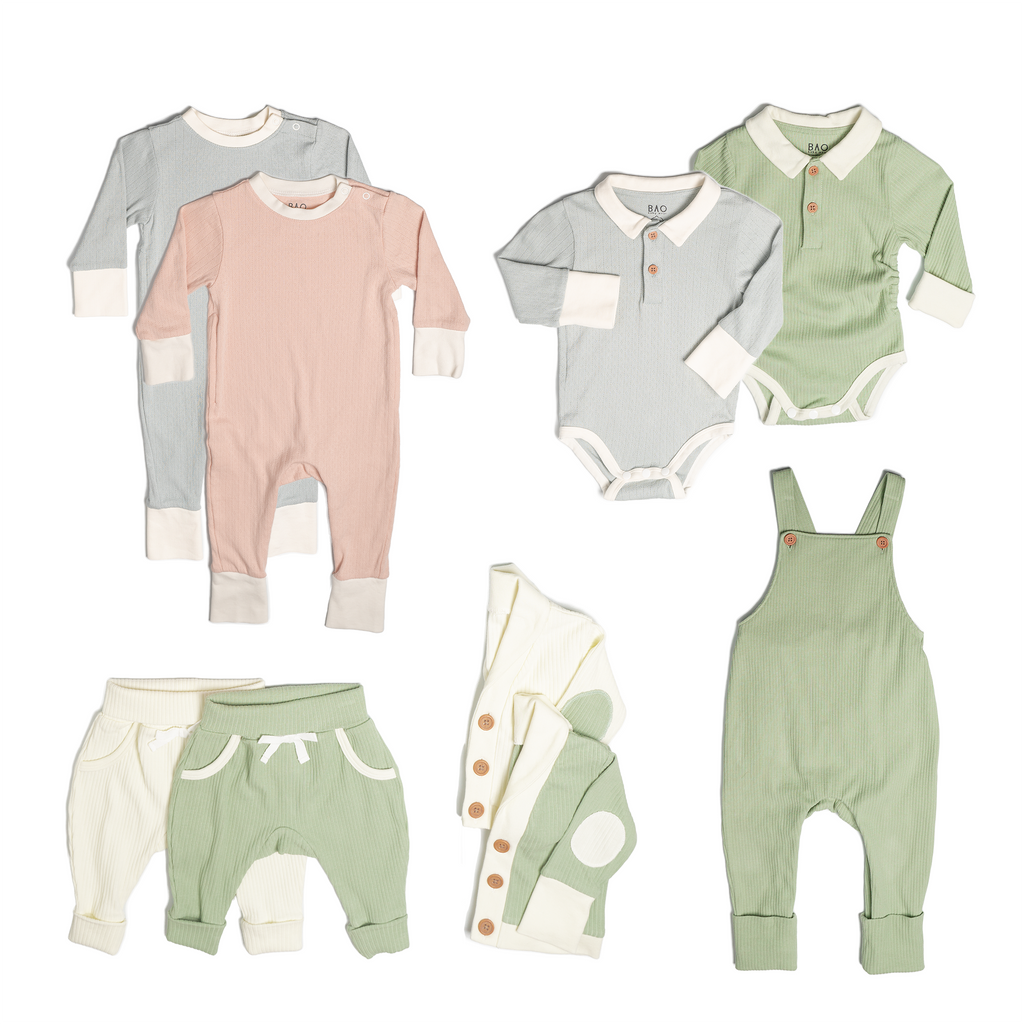 The ultimate earth-side bundle, consisting of a 2 sets of pointelle pyjamas, one in butterfly pea and one in peach, 2 pairs of ribbed cotton lounge pants, one in matcha and one in vanilla, 2 sets of ribbed cotton cardigans, one in matcha and one in vanilla, 2 sets of button bodysuits one in ribbed cotton matcha and one in pointelle cotton peach and one pair of overalls in matcha ribbed cotton.