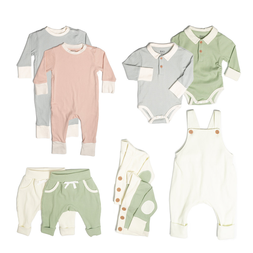 The ultimate earth-side bundle, consisting of a 2 sets of pointelle pyjamas, one in butterfly pea and one in peach, 2 pairs of ribbed cotton lounge pants, one in matcha and one in vanilla, 2 sets of ribbed cotton cardigans, one in matcha and one in vanilla, 2 sets of button bodysuits one in ribbed cotton matcha and one in pointelle cotton butterfly pea and one pair of overalls in vanilla ribbed cotton.