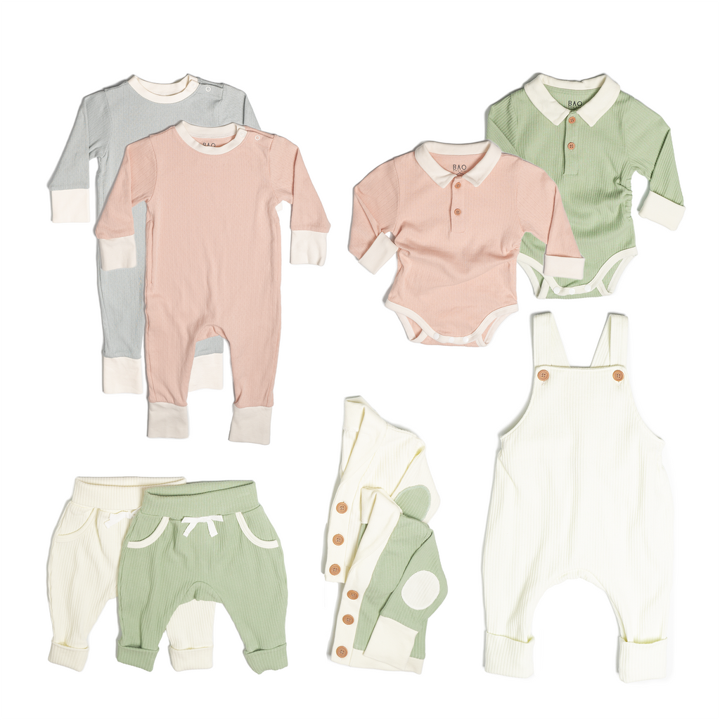 The ultimate earth-side bundle, consisting of a 2 sets of pointelle pyjamas, one in butterfly pea and one in peach, 2 pairs of ribbed cotton lounge pants, one in matcha and one in vanilla, 2 sets of ribbed cotton cardigans, one in matcha and one in vanilla, 2 sets of button bodysuits one in ribbed cotton matcha and one in pointelle cotton peach and one pair of overalls in vanilla ribbed cotton.