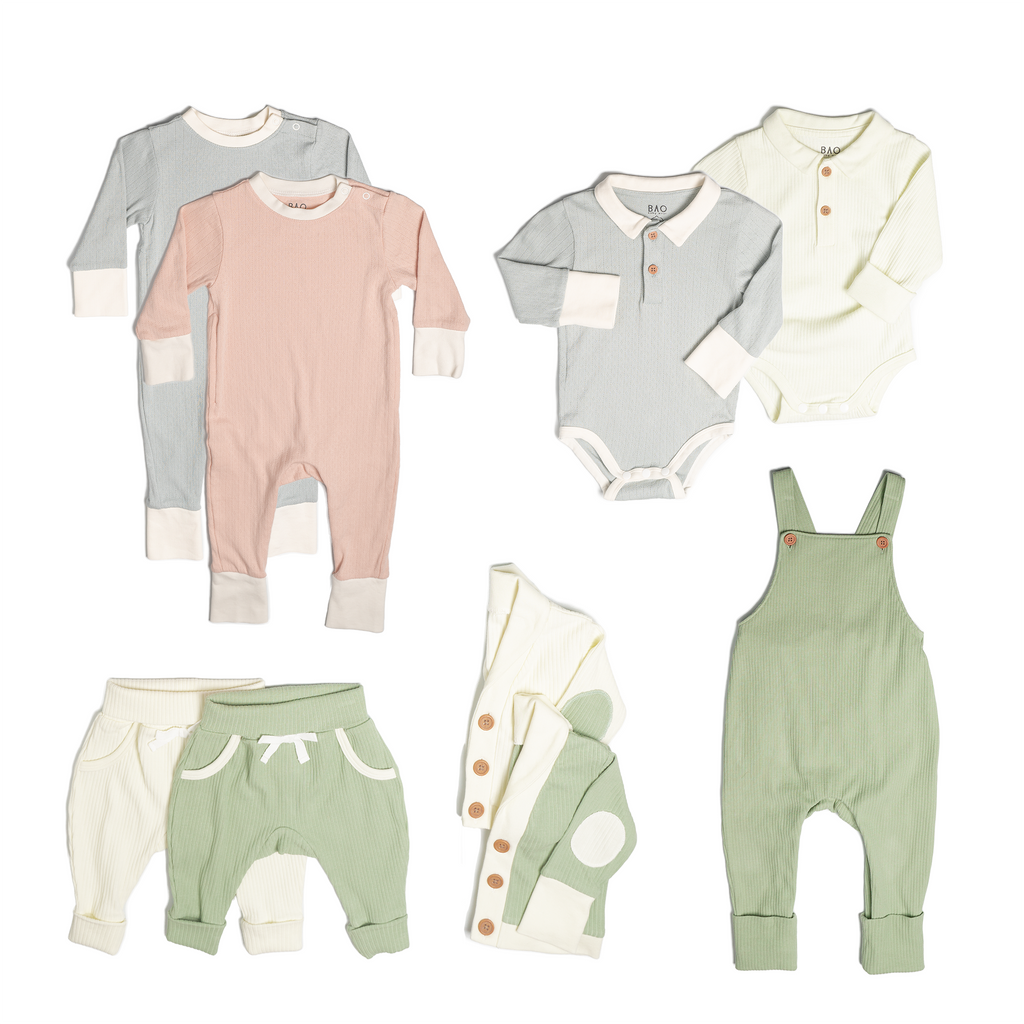 The ultimate earth-side bundle, consisting of a 2 sets of pointelle pyjamas, one in butterfly pea and one in peach, 2 pairs of ribbed cotton lounge pants, one in matcha and one in vanilla, 2 sets of ribbed cotton cardigans, one in matcha and one in vanilla, 2 sets of button bodysuits one in ribbed cotton vanilla and one in pointelle cotton butterfly pea and one pair of overalls in matcha ribbed cotton.