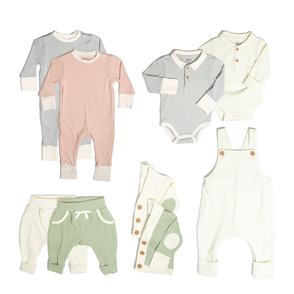 The ultimate earth-side bundle, consisting of a 2 sets of pointelle pyjamas, one in butterfly pea and one in peach, 2 pairs of ribbed cotton lounge pants, one in matcha and one in vanilla, 2 sets of ribbed cotton cardigans, one in matcha and one in vanilla, 2 sets of button bodysuits one in ribbed cotton vanilla and one in pointelle cotton butterfly pea and one pair of overalls in vanilla ribbed cotton.