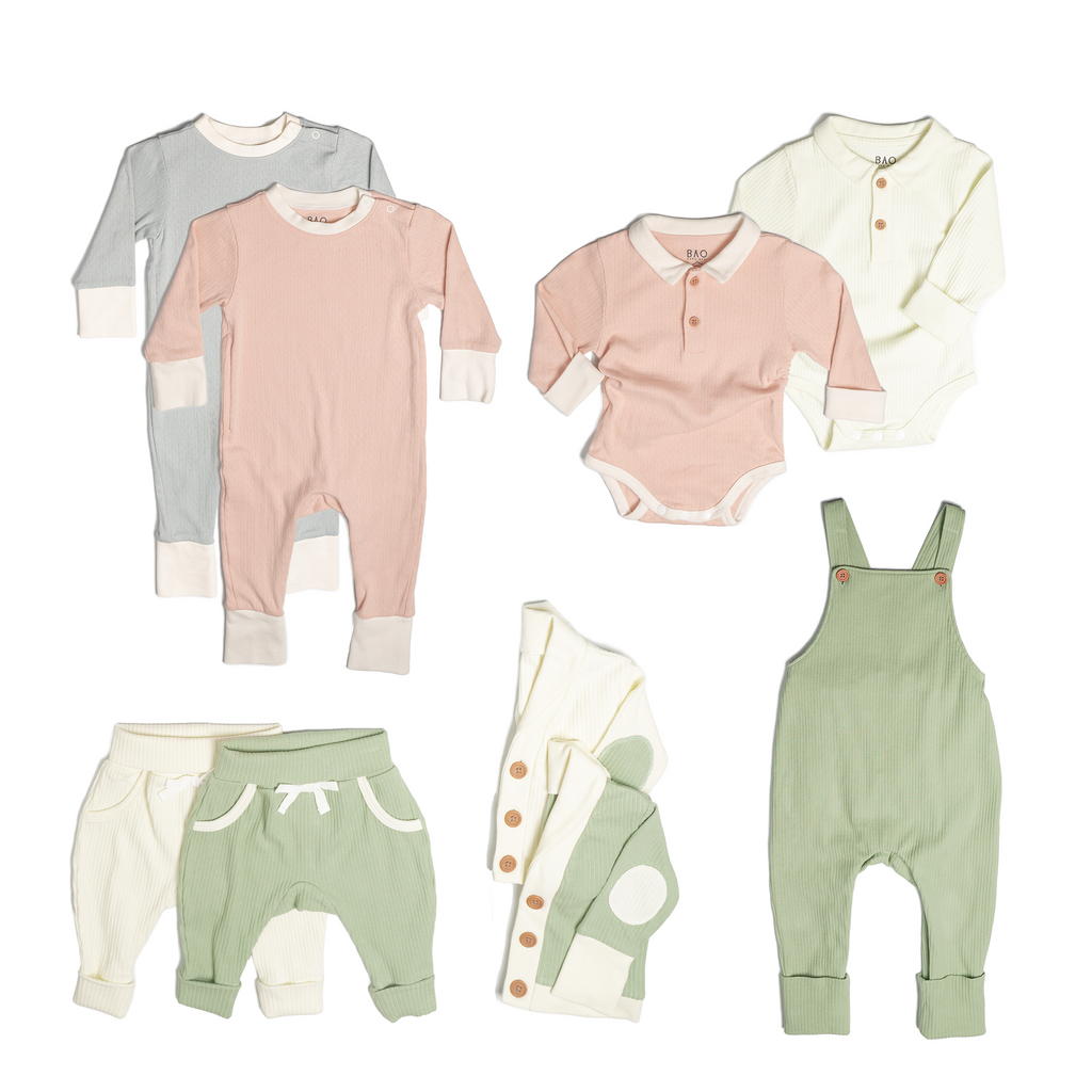 The ultimate earth-side bundle, consisting of a 2 sets of pointelle pyjamas, one in butterfly pea and one in peach, 2 pairs of ribbed cotton lounge pants, one in matcha and one in vanilla, 2 sets of ribbed cotton cardigans, one in matcha and one in vanilla, 2 sets of button bodysuits one in ribbed cotton vanilla and one in pointelle cotton peach and one pair of overalls in matcha ribbed cotton.